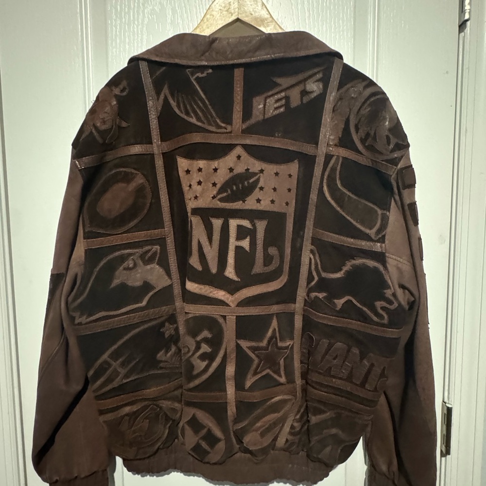 Vintage NFL suede jacket with NFL logo and other teams logos .
